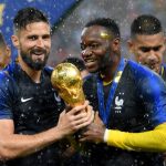 MOSCOW, RUSSIA - JULY 15: Olivier Giroud of France and Steve Mandanda of France celebrate their World Cup victory in the 2018 FIFA World Cup Final on March 15, 2018 in Moscow, Russia. (Photo by Matthias Hangst / Getty Images)