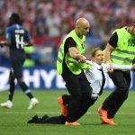 MOSCOW, RUSSIA - JULY 15: A pitch invader is being taken during the 2018 FIFA World Cup Final between France and Croatia at Luzhniki Stadium on July 15, 2018 in Moscow, Russia. (Photo by Shaun Botterill / Getty Images)