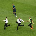 MOSCOW, RUSSIA - JULY 15: Pitch invaders are chased by security staff during the 2018 FIFA World Cup final between France and Croatia at Luzhniki Stadium on July 15, 2018 in Moscow, Russia. (Photo by Ryan Pierse / Getty Images)