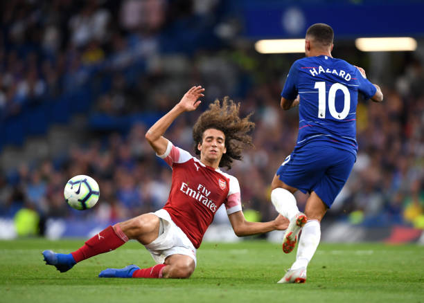 Guendouzi's amazing reaction to Aubameyang's miss shows why fans love him already 2 LONDON, ENGLAND - AUGUST 18: Matteo Guendouzi of Arsenal goes down whilst under pressure from Eden Hazard of Chelsea during the Premier League match between Chelsea FC and Arsenal FC at Stamford Bridge on August 18, 2018 in London, United Kingdom. (Photo by Mike Hewitt/Getty Images)