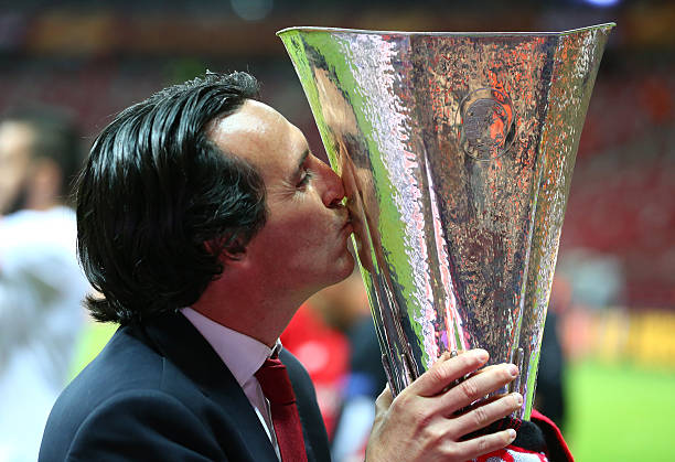 WARSAW, POLAND - MAY 27: Unai Emery, coach of Sevilla kisses the trophy after the UEFA Europa League Final match between FC Dnipro Dnipropetrovsk a...