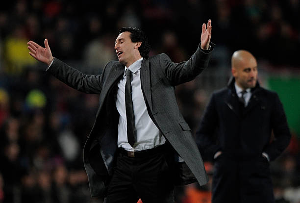 Valencia's coach Unai Emery (L) and Barcelona's coach Josep Guardiola react during the Spanish Cup second leg semi-final football match FC Barcelon...