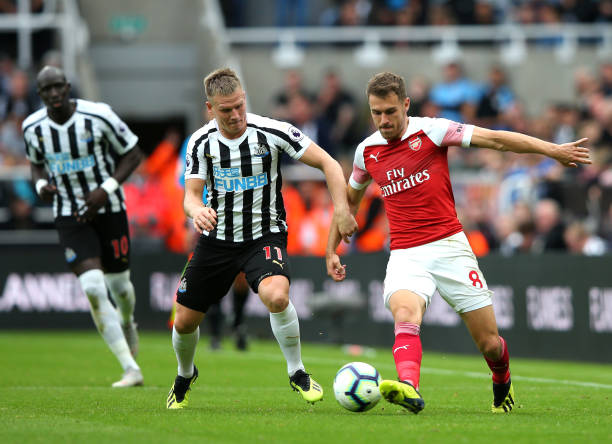 NEWCASTLE UPON TYNE, ENGLAND - SEPTEMBER 15: Aaron Ramsey of Arsenal is challenged by Matt Ritchie of Newcastle United during the Premier League ma...