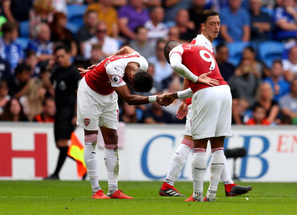 FA forget what body part fist bumps involve but that's not the weird bit 2 CARDIFF, WALES - SEPTEMBER 02: Alexandre Lacazette of Arsenal (9) celebrates with Pierre-Emerick Aubameyang as he scores his team's third goal during the Premier League match between Cardiff City and Arsenal FC at Cardiff City Stadium on September 2, 2018 in Cardiff, United Kingdom. (Photo by Catherine Ivill/Getty Images)