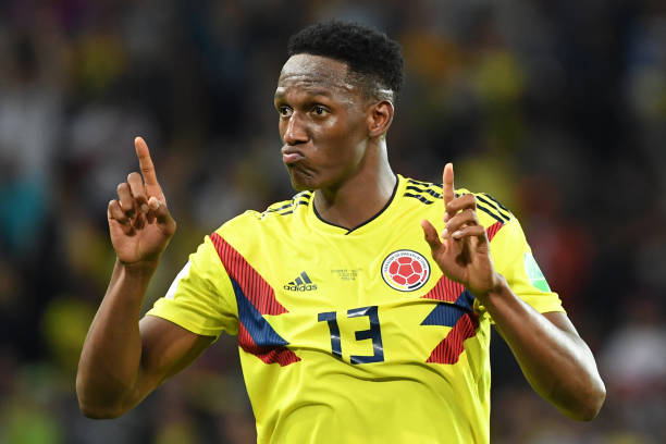 TOPSHOT - Colombia's defender Yerry Mina celebrates after scoring the equalizer during the Russia 2018 World Cup round of 16 football match between...