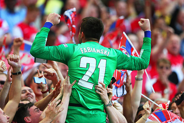 LONDON, ENGLAND - MAY 17: Lukasz Fabianski of Arsenal celebrates victory with fans after the FA Cup with Budweiser Final match between Arsenal and Hull City at Wembley Stadium on May 17, 2014 in London, England. (Photo by Clive Mason/Getty Images)