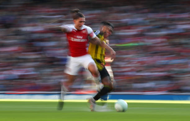 LONDON, ENGLAND - SEPTEMBER 29: Hector Bellerin of Arsenal is tackled during the Premier League match between Arsenal FC and Watford FC at Emirates...