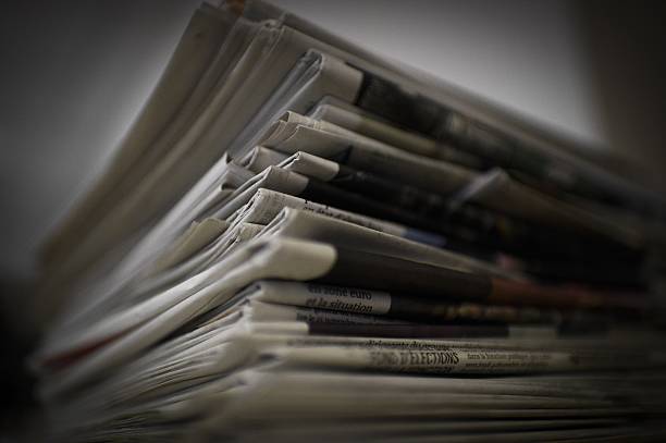 A picture taken on January 14, 2015 in Paris, shows a pile of newspapers and magazines. AFP PHOTO / MARTIN BUREAU (Photo credit should read MARTIN ...