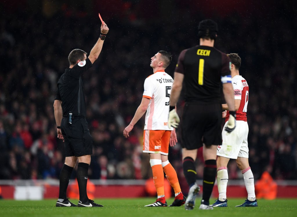 LONDON, ENGLAND - OCTOBER 31: Match referee David Coote shows a red card to Paudie O'Connor of Blackpool during the Carabao Cup Fourth Round match ...