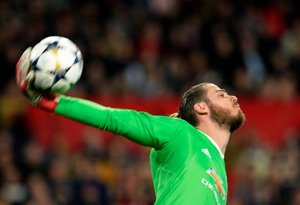 Manchester United's Spanish goalkeeper David de Gea throws the ball during the UEFA Champions League round of 16 first leg football match Sevilla F...