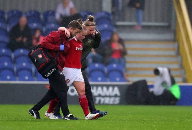 KINGSTON UPON THAMES, ENGLAND - OCTOBER 14: An injured Kim Little of Arsenal is taken off after being tackled by Drew Spence of Chelsea during the ...