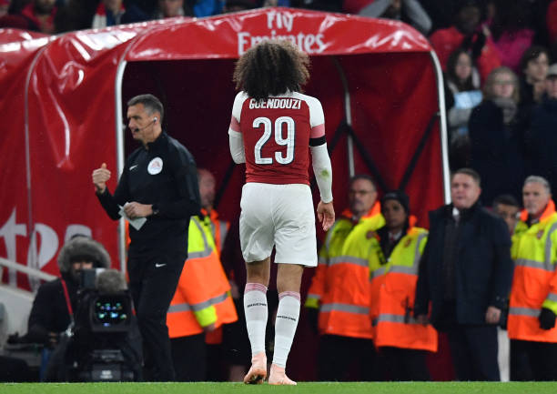 Arsenal's French midfielder Matteo Guendouzi leaves the pitch after being sent off for a second yellow card after a foul on Blackpool's English mid...