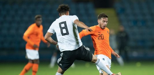 YEREVAN, ARMENIA - NOVEMBER 17: Jonas David of Germany is challenged by Orkun Kokcu of Netherlands during Germany U19 against Netherlands U19 UEFA Four Nations Tournament on November 17, 2018 in Yerevan, Armenia. (Photo by Maja Hitij/Bongarts/Getty Images)