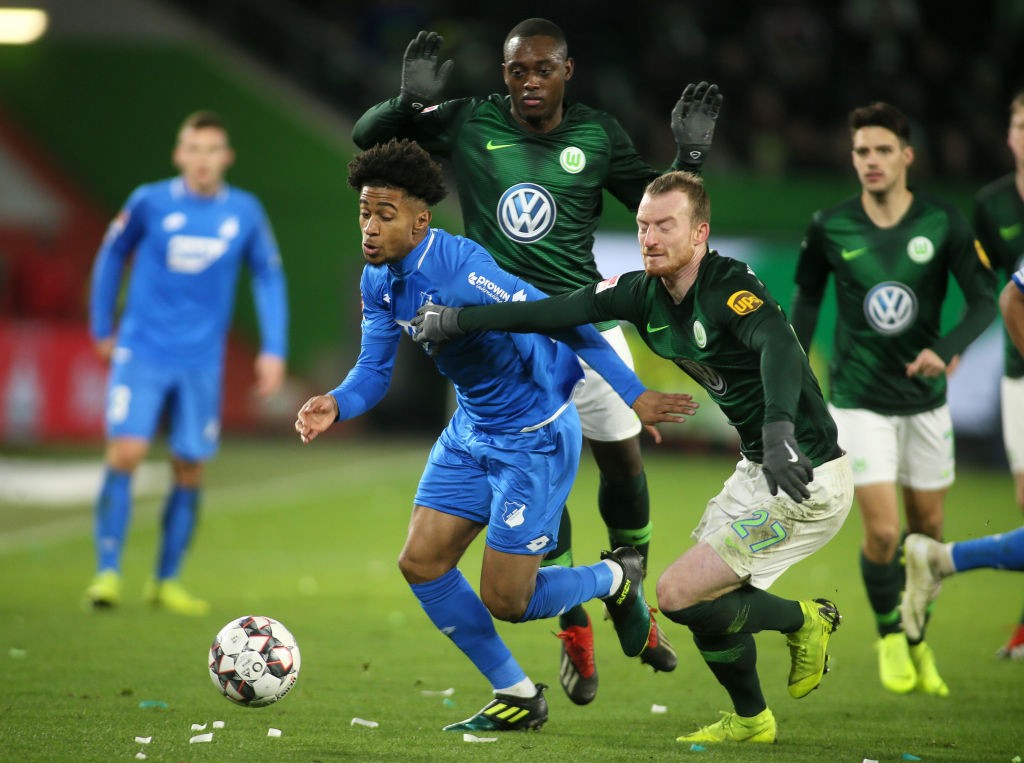 WOLFSBURG, GERMANY - DECEMBER 08: Reiss Nelson of Hoffenheim (L) fights for the ball with Maximilian Arnold of Wolfsburg during the Bundesliga matc...