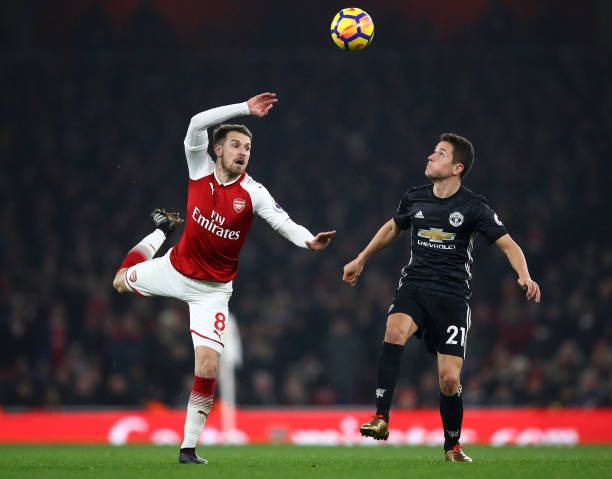 LONDON, ENGLAND - DECEMBER 02: Aaron Ramsey of Arsenal in action with Ander Herrera of Manchester United during the Premier League match between Ar...