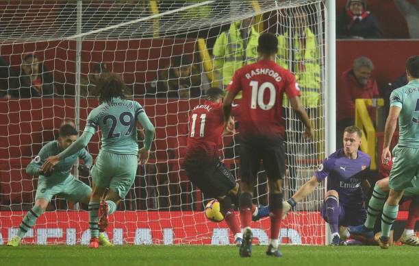 Manchester United's French striker Anthony Martial (C) scores their first goal to equalise 1-1 during the English Premier League football match between Manchester United and Arsenal at Old Trafford in Manchester, north west England, on December 5, 2018. (Photo by Oli SCARFF / AFP)