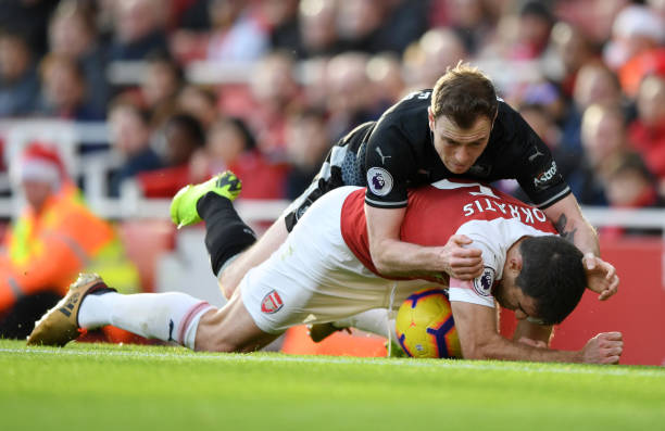Cheats! Sean Dyche and media show their hypocrisy after Arsenal win 2 LONDON, ENGLAND - DECEMBER 22: Sokratis Papastathopoulos of Arsenal clashes with Ashley Barnes of Burnley during the Premier League match between Arsenal FC and Burnley FC at Emirates Stadium on December 22, 2018 in London, United Kingdom. (Photo by Shaun Botterill/Getty Images)