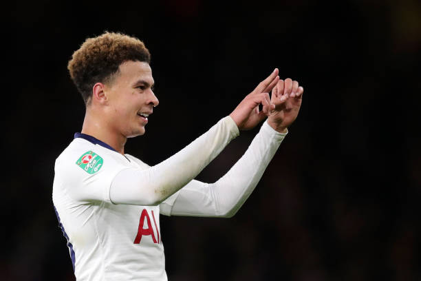 LONDON, ENGLAND - DECEMBER 19: Dele Alli of Tottenham Hotspur gestures the score to the crowd after being hit by a water bottle during the Carabao ...