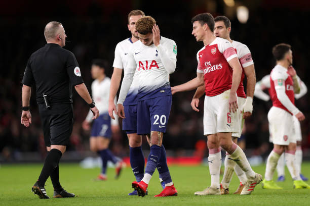 Arsenal apologise to Tottenham 2 LONDON, ENGLAND - DECEMBER 19: Dele Alli of Tottenham Hotspur reacts after being hit by a water bottle during the Carabao Cup Quarter Final match between Arsenal and Tottenham Hotspur at Emirates Stadium on December 19, 2018 in London, United Kingdom. (Photo by Alex Morton/Getty Images)