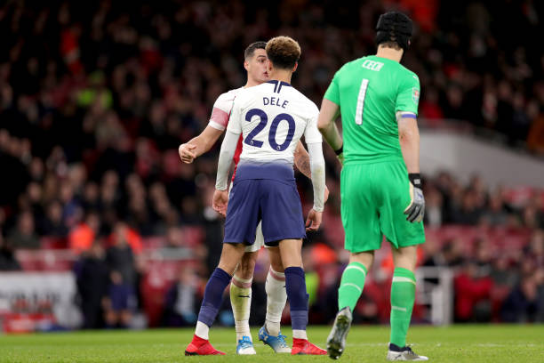 LONDON, ENGLAND - DECEMBER 19: Dele Alli of Tottenham Hotspur reacts with Granit Xhaka of Arsenal during the Carabao Cup Quarter Final match betwee...