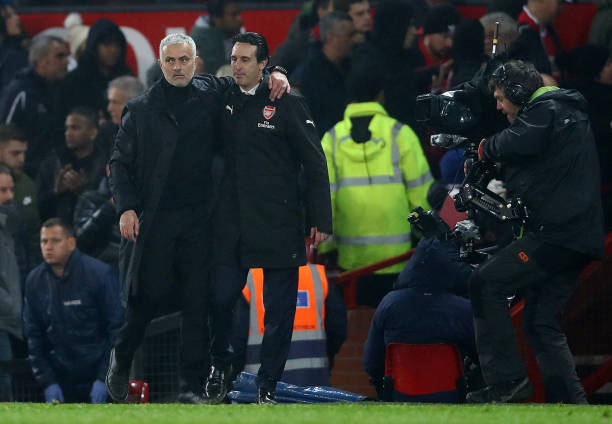 MANCHESTER, ENGLAND - DECEMBER 05: Jose Mourinho, Manager of Manchester United and Unai Emery, Manager of Arsenal hug each other after the Premier ...
