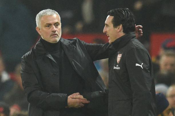 Manchester United's Portuguese manager Jose Mourinho (L) shakes hands with Arsenal's Spanish head coach Unai Emery (R) at the end of the English Pr...