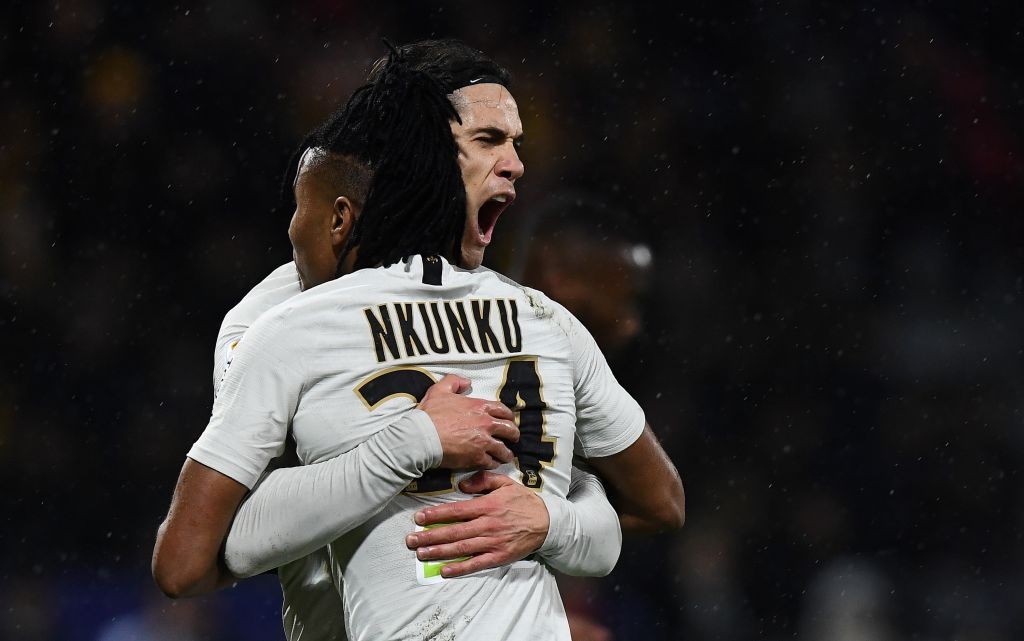 Paris Saint-Germain's Uruguayan forward Edinson Cavani (L) is congratulated by Paris Saint-Germain's French midfielder Christopher Nkunku after sco...