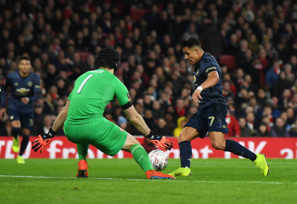 LONDON, ENGLAND - JANUARY 25: Alexis Sanchez of Manchester United beats Petr Cech of Arsenal as he scores his team's first goal during the FA Cup F...