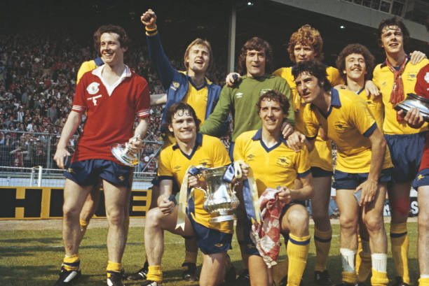 LONDON, UNITED KINGDOM - MAY 12: Arsenal player Liam Brady (l) wearing a Manchester United shirt leads the celebrations after their 3-2 victory in ...