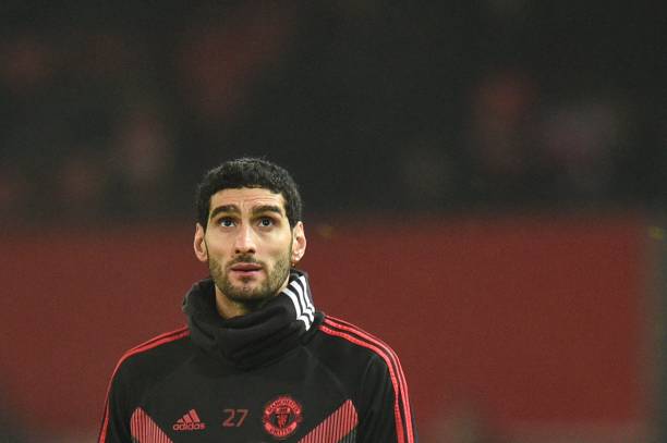 Manchester United's Belgian midfielder Marouane Fellaini warms up for the English Premier League football match between Manchester United and Arsen...