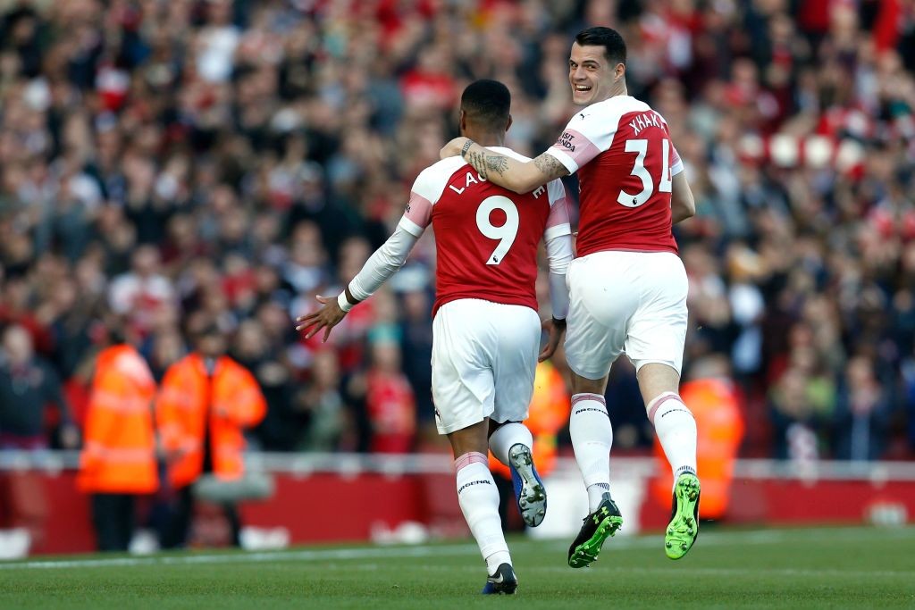 Arsenal's French striker Alexandre Lacazette celebrates with Arsenal's Swiss midfielder Granit Xhaka after scoring during the English Premier Leagu...