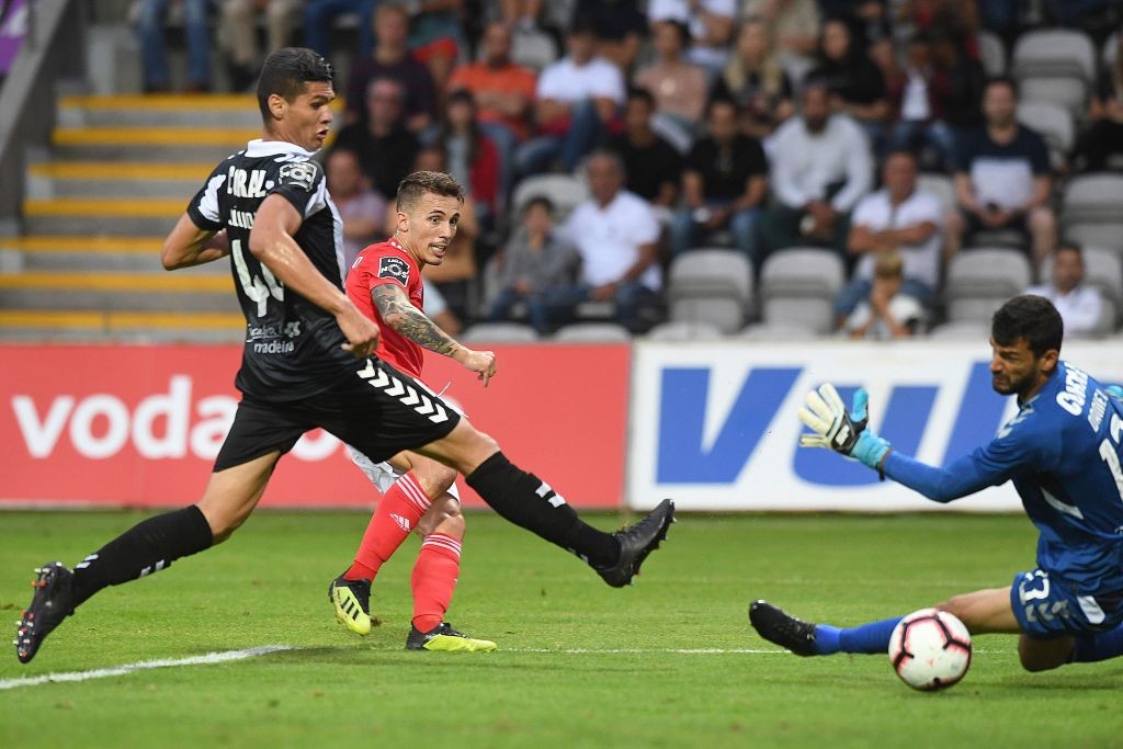 Benfica's Spanish defender Alejandro Grimaldo (back C) scores past Nacional's Brazilian goalkeeper Daniel Guimaraes (R) during the Portuguese leagu...