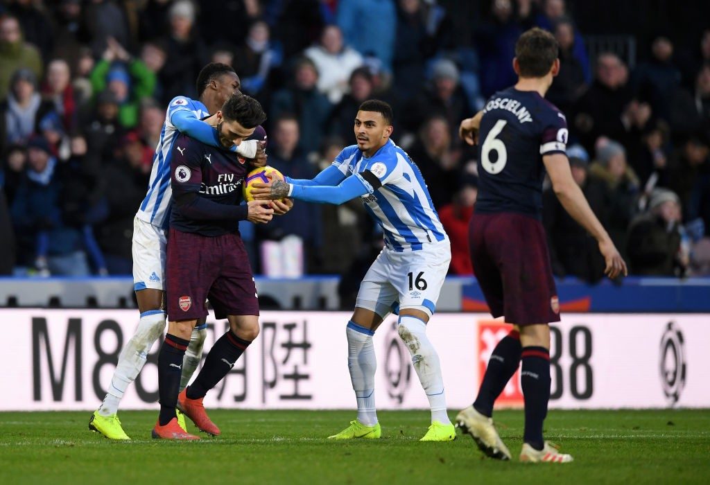 Player ratings vs Huddersfield Town: Injury-ravaged Arsenal scrape uninspiring win 3 HUDDERSFIELD, ENGLAND - FEBRUARY 09: Adama Diakhaby and Karlan Grant of Huddersfield Town attempt to get the ball off Sead Kolasinac of Arsenal after their team's first goal during the Premier League match between Huddersfield Town and Arsenal FC at John Smith's Stadium on February 9, 2019 in Huddersfield, United Kingdom. (Photo by Gareth Copley/Getty Images)