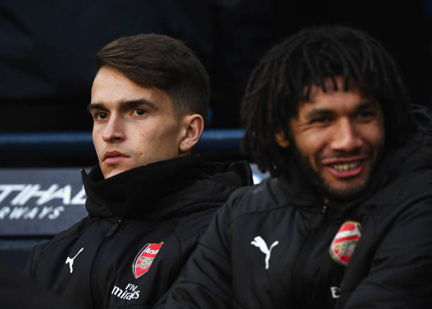 MANCHESTER, ENGLAND - FEBRUARY 03: Denis Suarez of Arsenal sits on the bench alongside Mohamed Elneny of Arsenal prior to the Premier League match ...