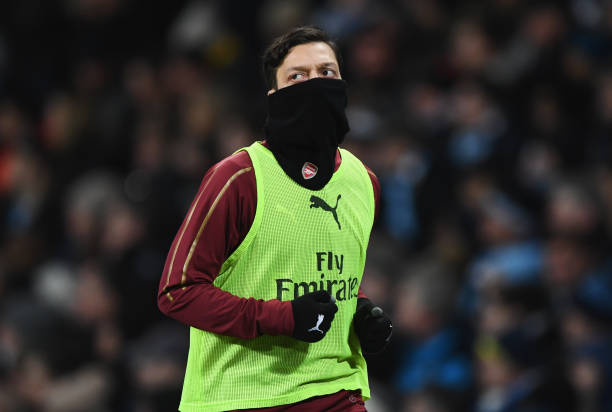 MANCHESTER, ENGLAND - FEBRUARY 03: Substitute Mesut Ozil of Arsenal warms up during the Premier League match between Manchester City and Arsenal FC...