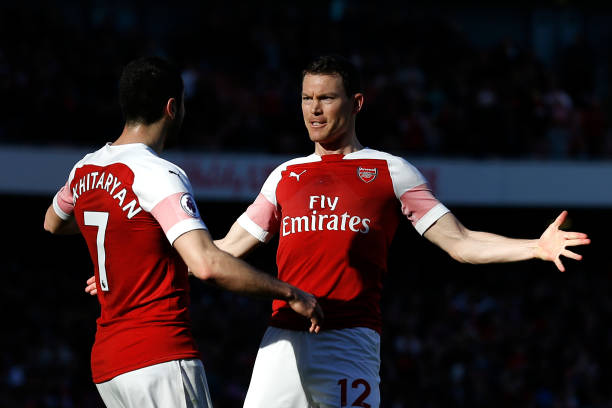 Arsenal's Armenian midfielder Henrikh Mkhitaryan (L) celebrates with Arsenal's Swiss defender Stephan Lichtsteiner after scoring their second goal ...