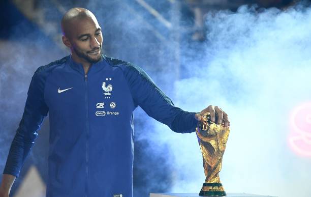 France's midfielder Steven N'Zonzi looks at the 2018 World Cup trophy during a ceremony to celebrate the victory of the 2018 World Cup before the l...