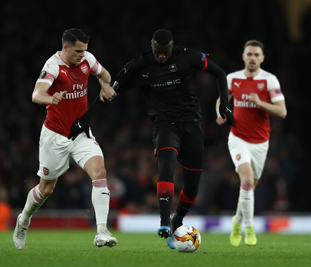 LONDON, ENGLAND - MARCH 14:  M'Baye Niang of Stade Rennais holds of Granit Xhaka of Arsenal during the UEFA Europa League Round of 16 Second Leg match between Arsenal and Stade Rennais at Emirates Stadium on March 14, 2019, in London, England. (Photo by Bryn Lennon/Getty Images)