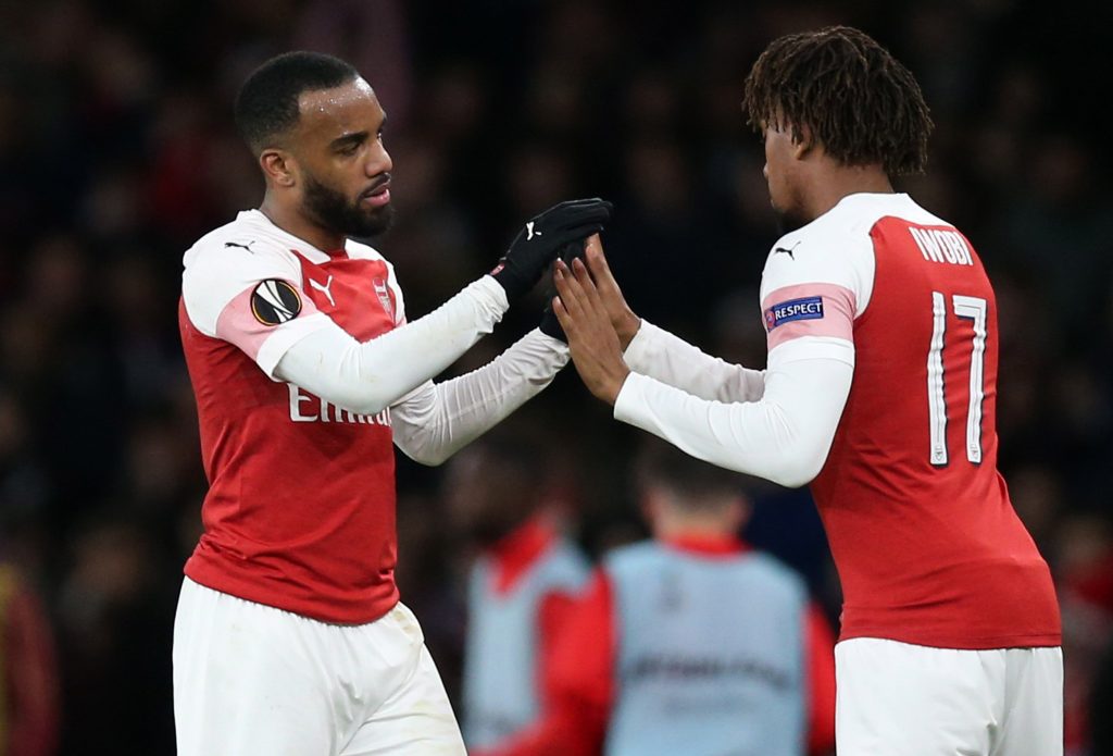 LONDON, ENGLAND - MARCH 14: Alexandre Lacazette of Arsenal embraces teammate Alex Iwobi as he is substituted during the UEFA Europa League Round of 16 Second Leg match between Arsenal and Stade Rennais at Emirates Stadium on March 14, 2019, in London, England. (Photo by Alex Morton/Getty Images)