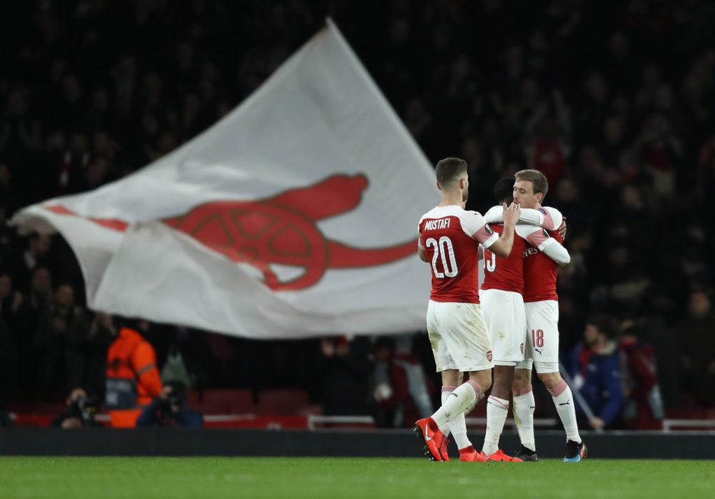 LONDON, ENGLAND - MARCH 14: Nacho Monreal of Arsenal celebrates with teammates Ainsley Maitland-Niles and Shkodran Mustafi after the UEFA Europa League Round of 16 Second Leg match between Arsenal and Stade Rennais at Emirates Stadium on March 14, 2019, in London, England. (Photo by Bryn Lennon/Getty Images)