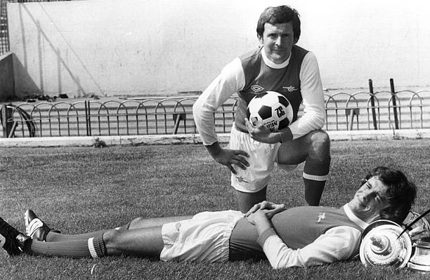 17th July 1979: Arsenal Footballers John Hollins and David O'Leary at Highbury. O'Leary appears to be using the FA Cup as a headrest. (Photo by Evening Standard/Getty Images)