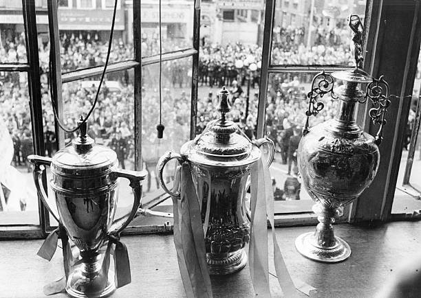 7 programmes: Arsenal on TV 20 March 2019 6 1st January 1970: Three of the trophies that Arsenal won during their successful 1970-71 season. From left to right are : the F A Youth Cup, the FA Cup and the League Championship Trophy. (Photo by Wood/Evening Standard/Getty Images)
