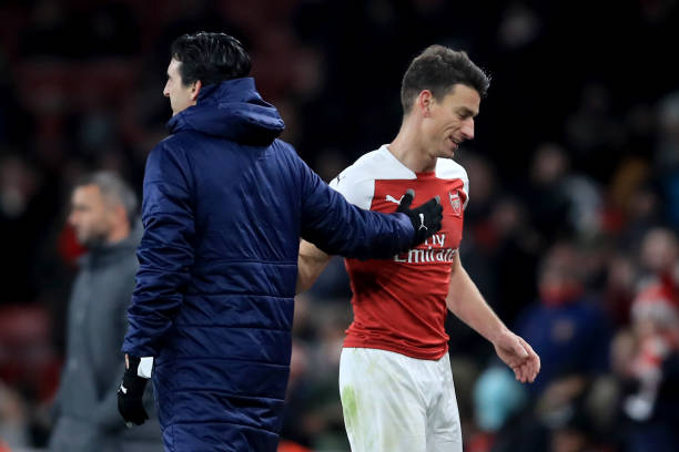 LONDON, ENGLAND - DECEMBER 13: Laurent Koscielny of Arsenal with Unai Emery manager of Arsenal during the UEFA Europa League Group E match between ...