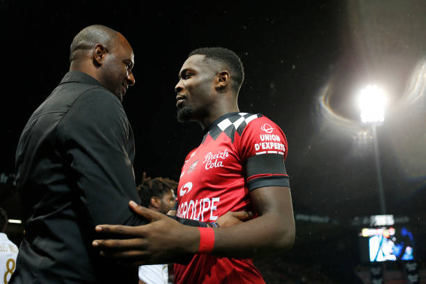 Nice's French head coach Patrick Vieira (L) speaks with Guingamp's French forward Marcus Thuram during the French L1 football match between Guingam...