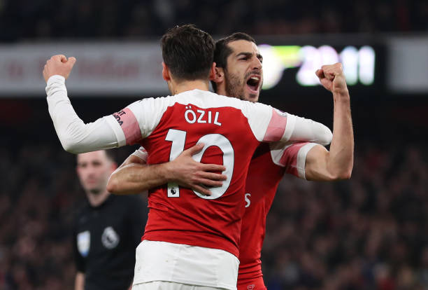 LONDON, ENGLAND - FEBRUARY 27: Henrikh Mkhitaryan of Arsenal celebrates scoring his sides second goal with Mesut Ozil of Arsenal during the Premier...