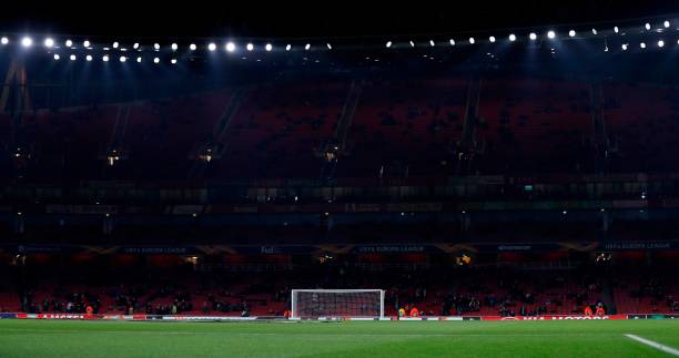 Fans sit in the empty stands ahead of the UEFA Europa league Group E football match between Arsenal and FK Qarabag at the Emirates stadium in Londo...
