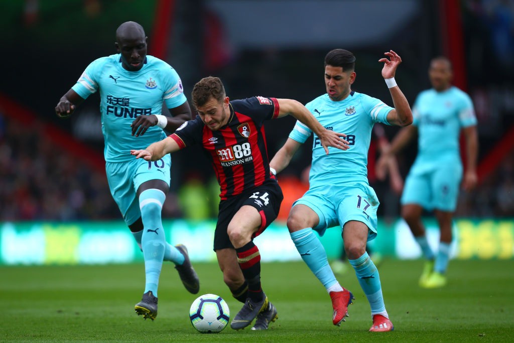 BOURNEMOUTH, ENGLAND - MARCH 16: Ryan Fraser of AFC Bournemouth is challenged by Ayoze Perez of Newcastle United and Mohamed Diame of Newcastle Uni...
