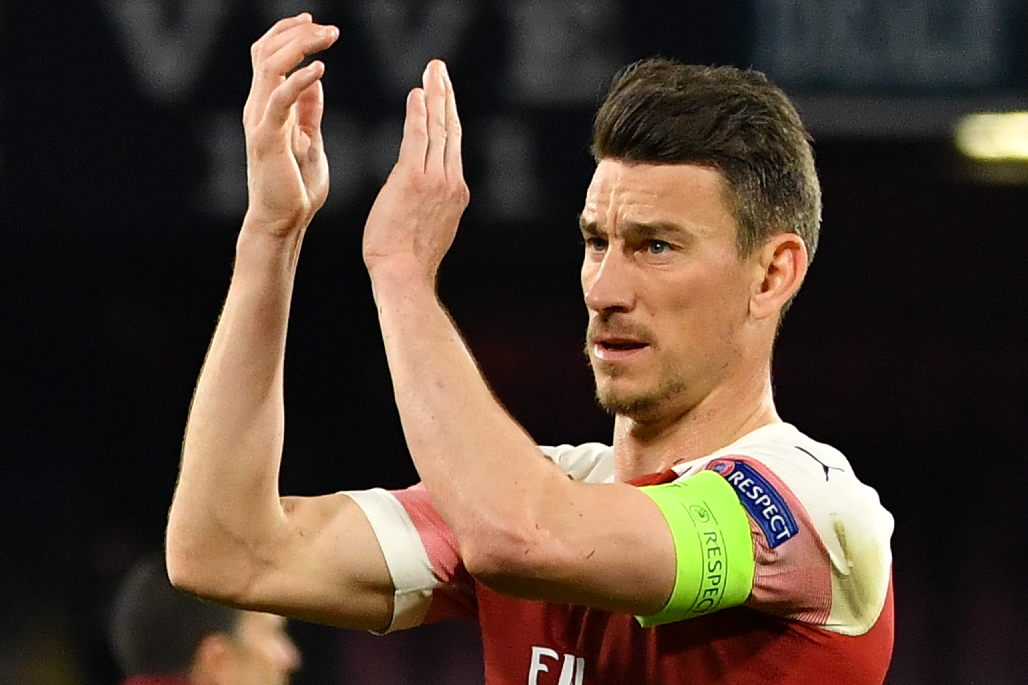 Arsenal's French defender Laurent Koscielny acknowledges the public at the end of the UEFA Europa League quarter-final second leg football match Na...