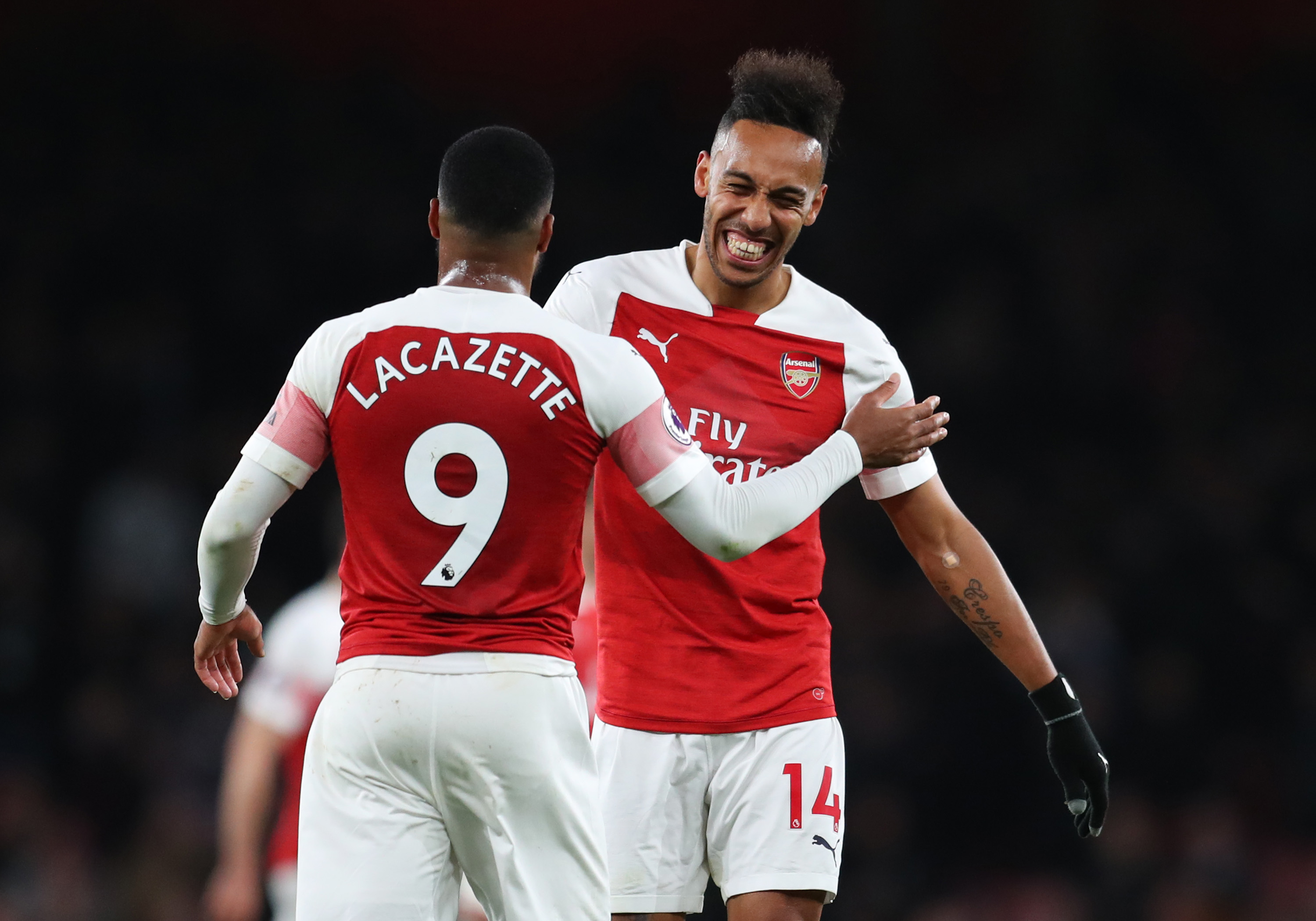 Pierre-Emerick Aubameyang (14) and Alexandre Lacazette of Arsenal celebrate victory after the the Premier League match between Arsenal FC and Newca...