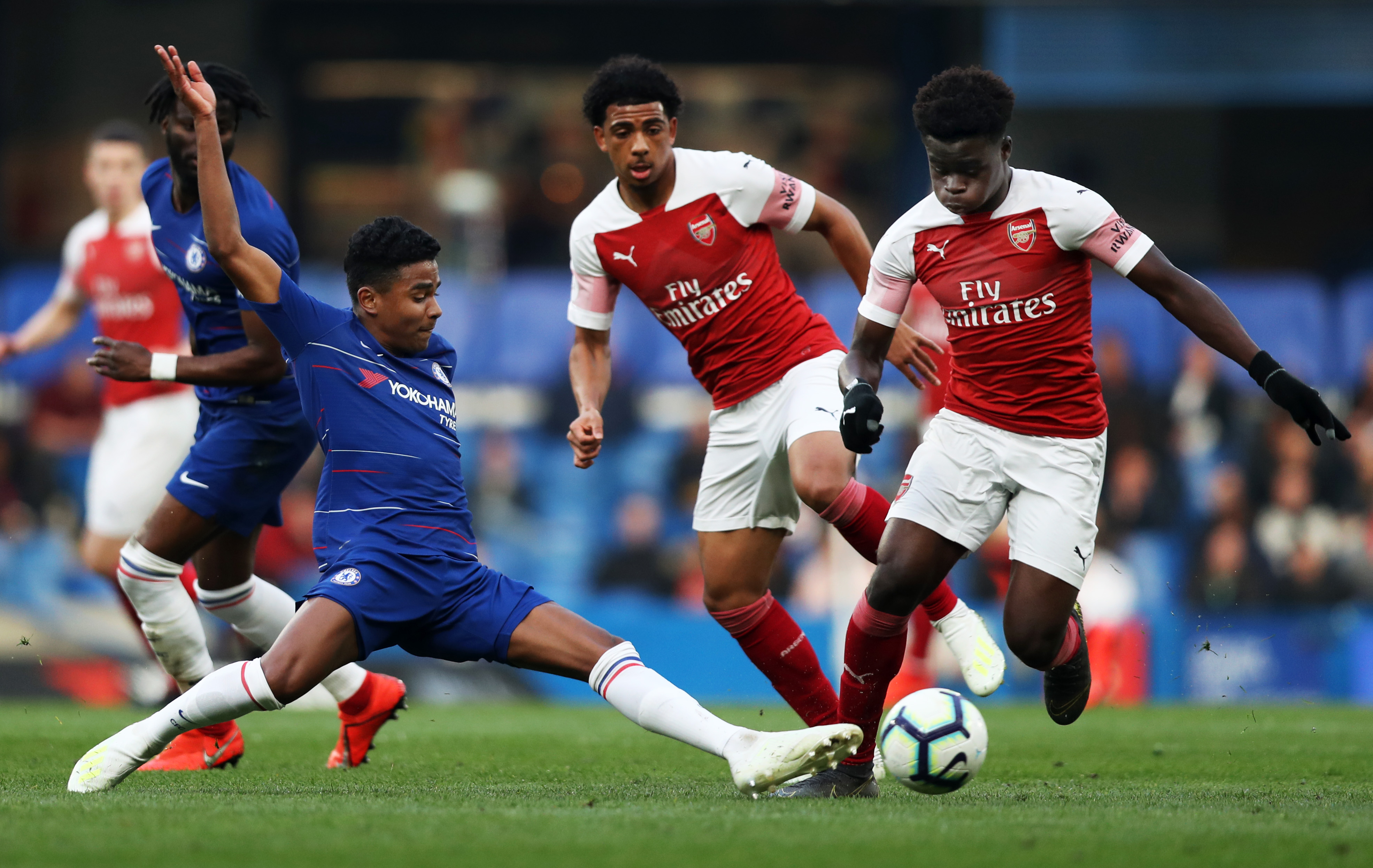 Ian Maatsen of Chelsea stretches for the ball that Bukayo Saka of Arsenal controls during the Premier League 2 match between Chelsea and Arsenal at...